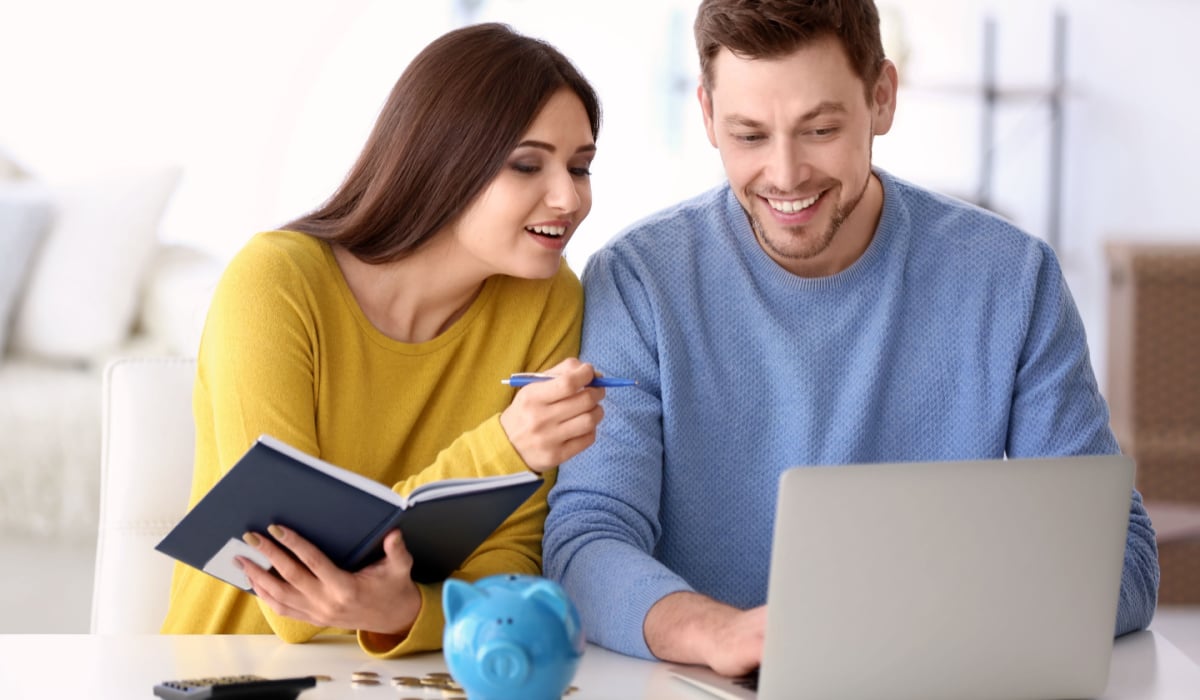 Millennial couple checking budget of savings to buy house