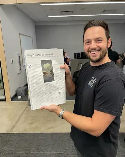Eric Holding an Article he wrote